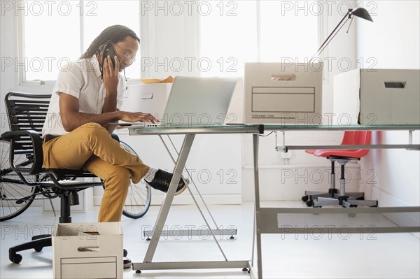 Black businessman working in new office