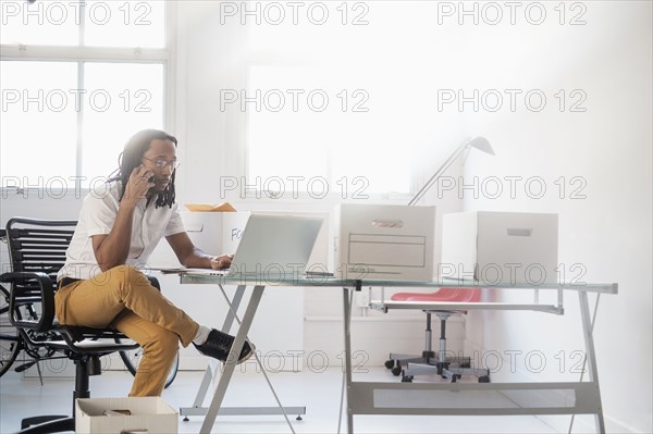 Black businessman working in new office
