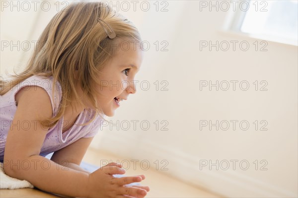 Caucasian girl laying on floor