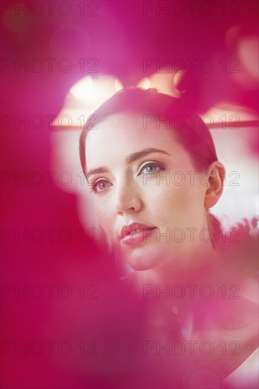 Caucasian woman obscured by flowers