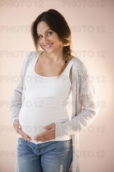 Pregnant Caucasian woman holding her belly