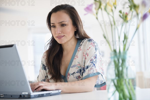 Woman using laptop at desk