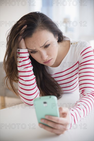 Stressed woman using cell phone