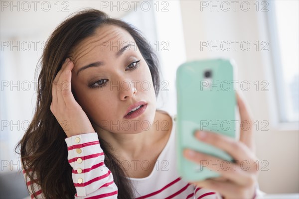 Stressed woman using cell phone