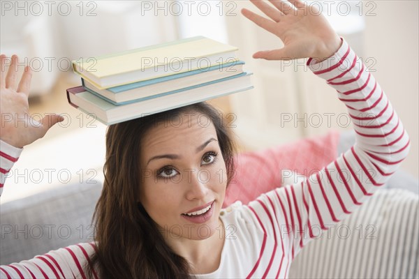 Woman balancing books on head