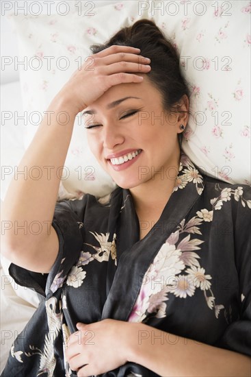 Woman laughing on bed