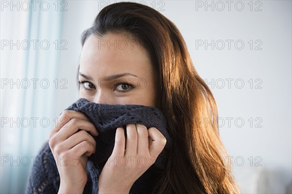 Woman wrapped in warm sweater