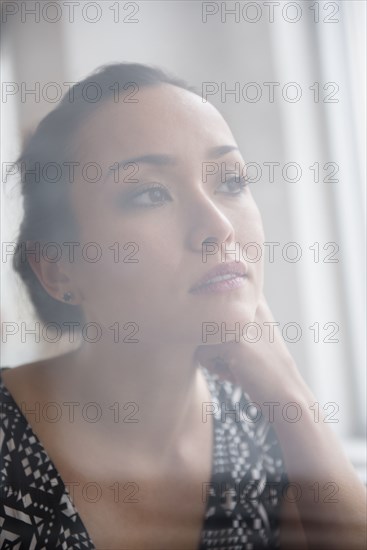 Tranquil woman looking out window