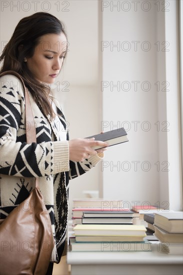 Woman shopping for books in bookstore