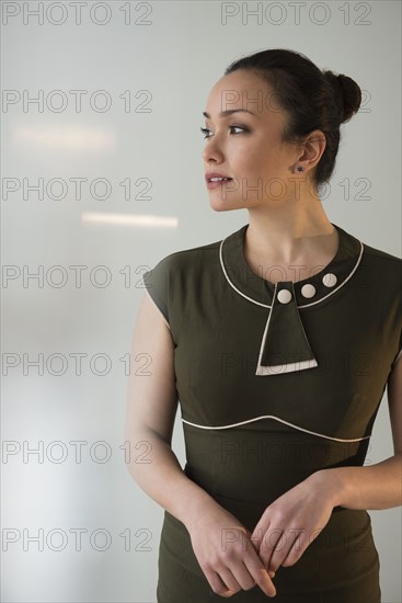 Serious businesswoman standing in office