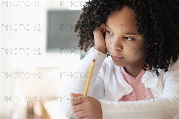 African American student writing in classroom