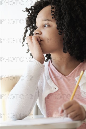 African American student writing in classroom