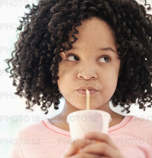 African American girl drinking with straw