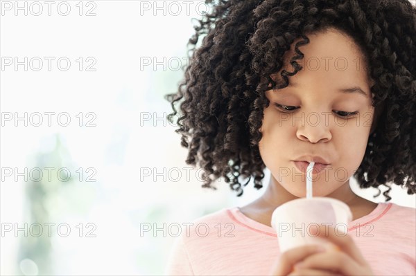 African American girl drinking with straw