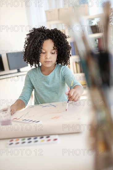 African American girl painting with watercolors