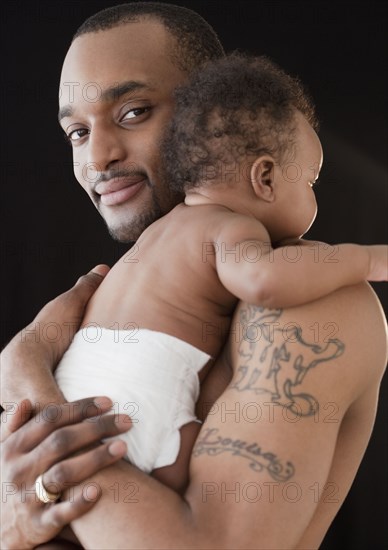 African man holding baby