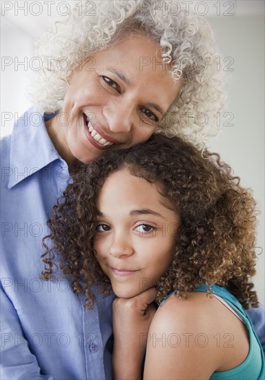 Grandmother and granddaughter hugging