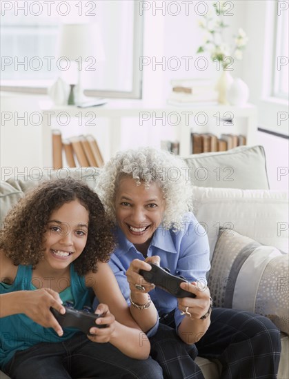 Grandmother and granddaughter playing video game