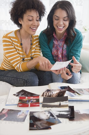 Friends looking at old photographs together