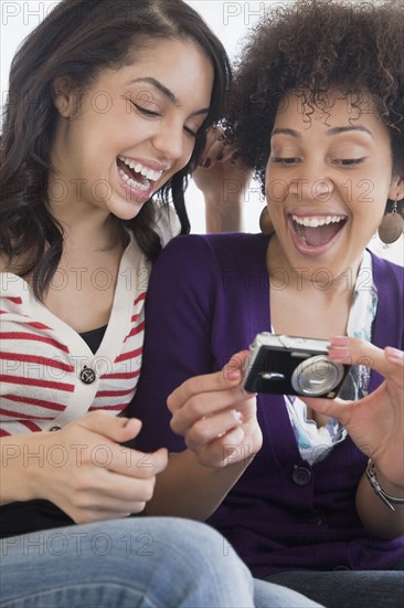 Friends looking at photographs on digital camera