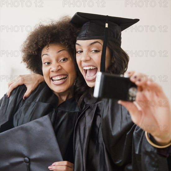 Graduating friends taking self-portrait