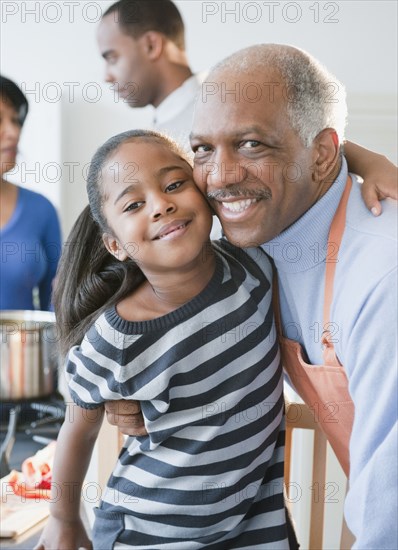 African American grandfather hugging granddaughter