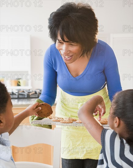 African American grandmother giving grandchildren cookies