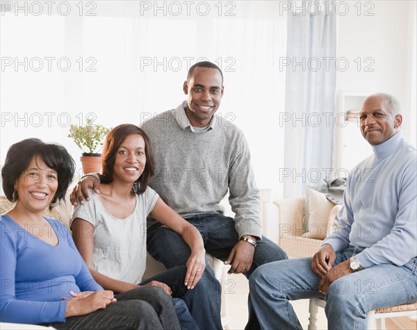 African American family sitting in living room