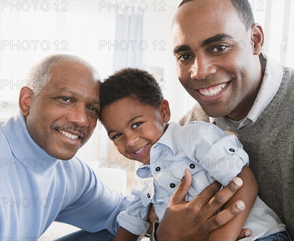 African American grandfather smiling with son and grandson