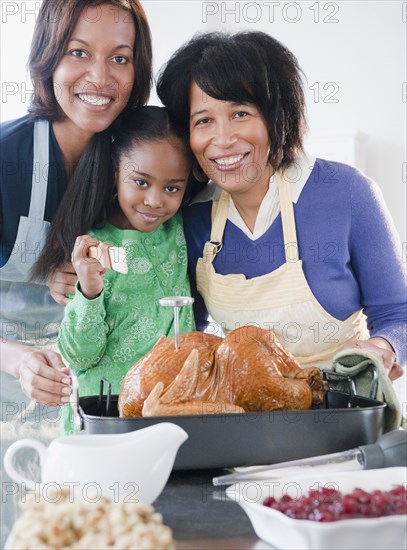 Black family preparing Thanksgiving dinner