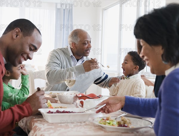 African American family enjoying Thanksgiving dinner