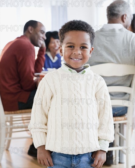 African American boy smiling with family in background