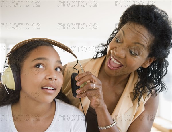 Mother shouting at daughter listening to headphones