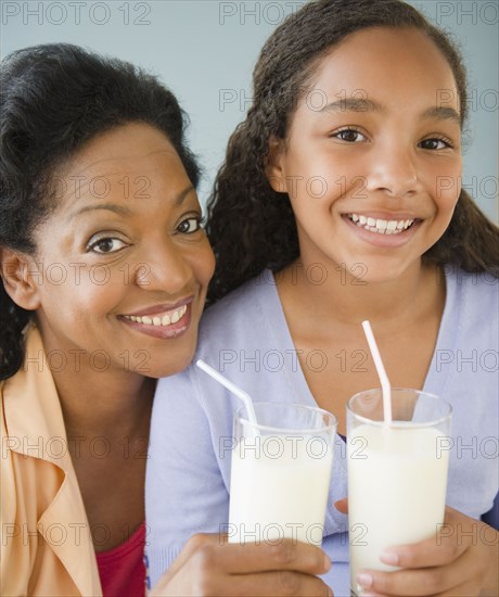 Mother and daughter drinking milk together
