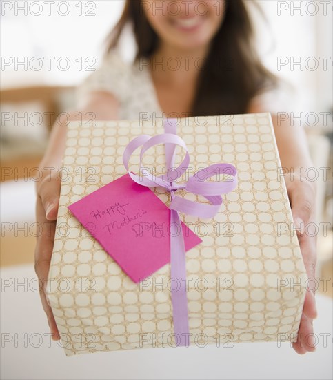 Indian woman holding out Mother's Day gift