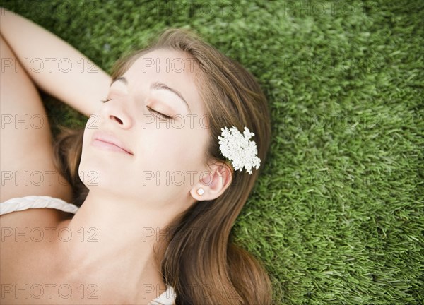 Tranquil Indian woman sleeping in grass