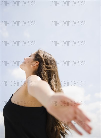 Tranquil Indian woman with arms outstretched