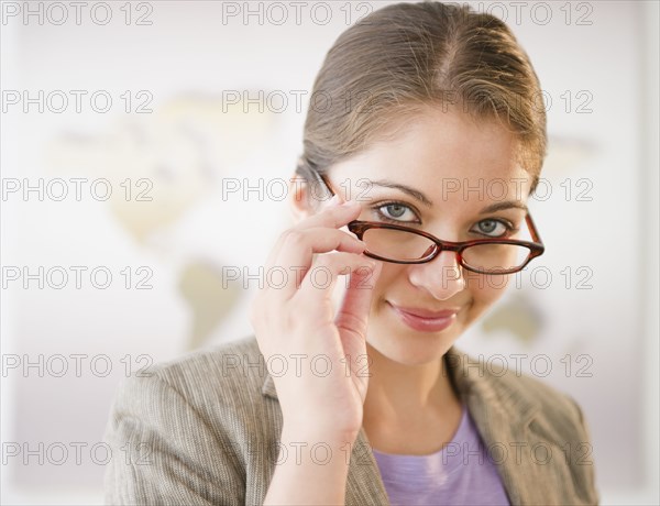 Indian businesswoman adjusting eyeglasses