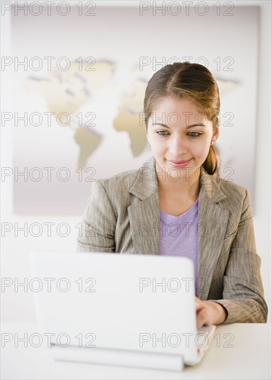 Indian businesswoman using laptop in office