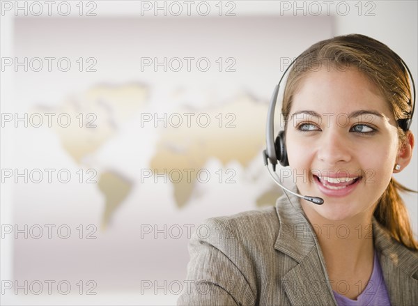 Indian businesswoman talking on headset in office