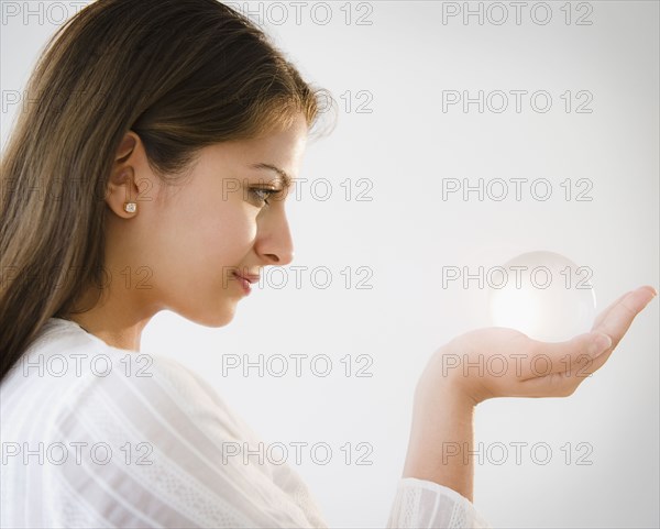 Indian woman looking at glass ball