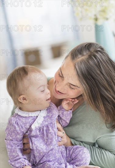 Caucasian mother playing with baby with Down Syndrome