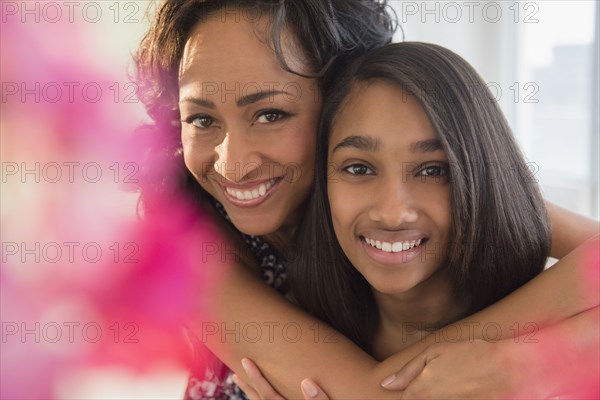 Smiling mother and daughter hugging