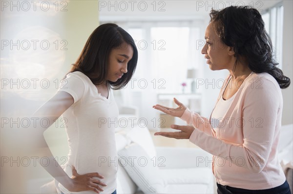 Mother scolding frustrated daughter