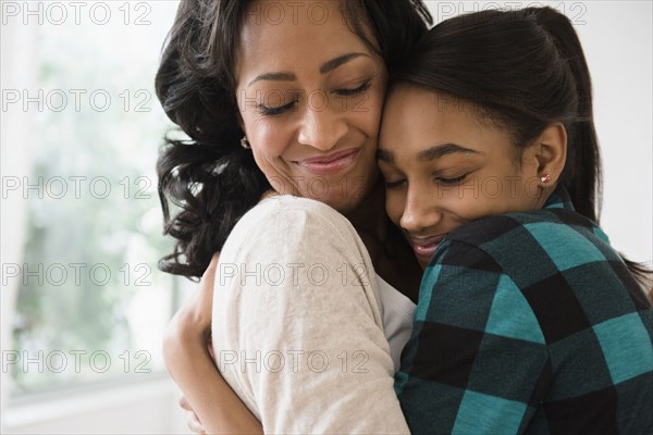 Mother and daughter hugging