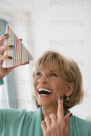 Older Caucasian woman wearing party hat