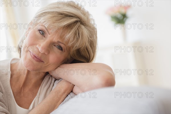 Older Caucasian woman relaxing on sofa