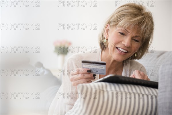 Older Caucasian woman online shopping with digital tablet