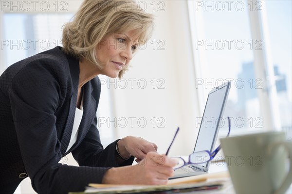 Caucasian businesswoman using laptop