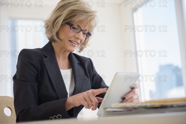 Caucasian businesswoman using digital tablet